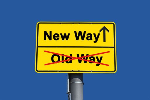 Yellow sign with black lettering. Below the word old crossed out in red and above it the word new with an arrow.