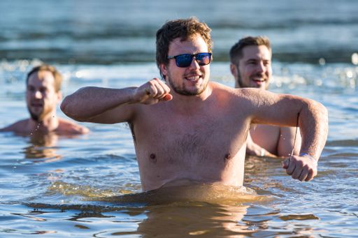 People enjoy traditional cold water swimming in Plumlov reservoir during Christmas in winter