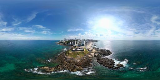 A drone view of a Barra Lighthouse against the Salvador cityscape in Brazil