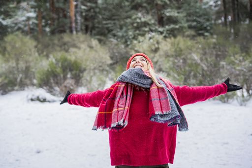 Beauty Joyful Model Girl laughing and having fun in winter park.