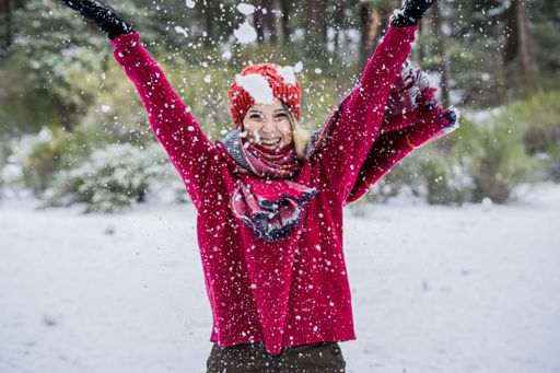 Beauty Joyful Model Girl laughing and having fun in winter park.