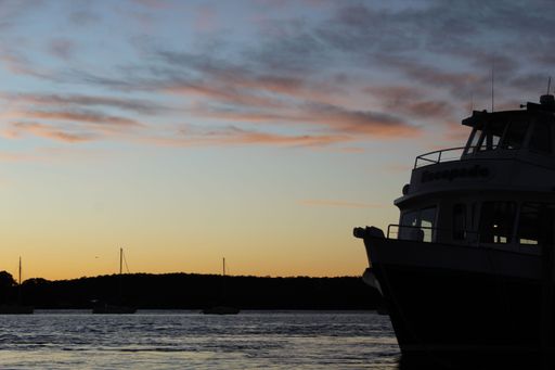 The silhouette of a ship in Batemans Bay at sunset. Australia.