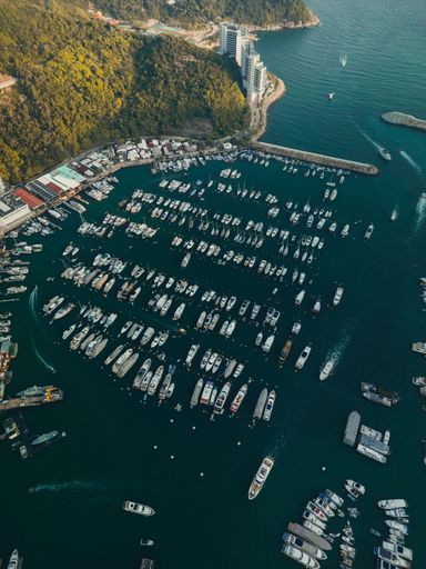 An aerial view of boats on the Aberdeen harbor near downtown buildings in Hong Kong