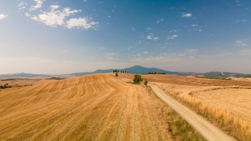 An aerial view of the Tuscany fields located in Italy seen on a beautiful sunny day