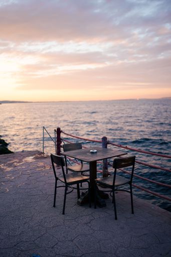 A vertical shot of an empty table on the beach