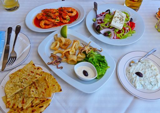 A high angle shot of delicious seafood and salad on plates