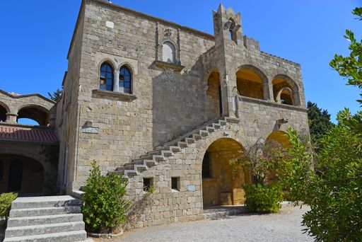 A low angle shot of the facade of a magnificent fortress surrounded by trees