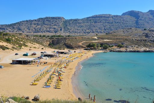 A high angle shot of people enjoying the sunny day by the ocean
