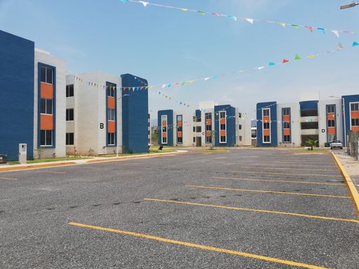 A low angle shot of modern buildings surrounding a parking lot