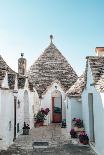 A vertical shot of typical buildings in Alberobello, Italy