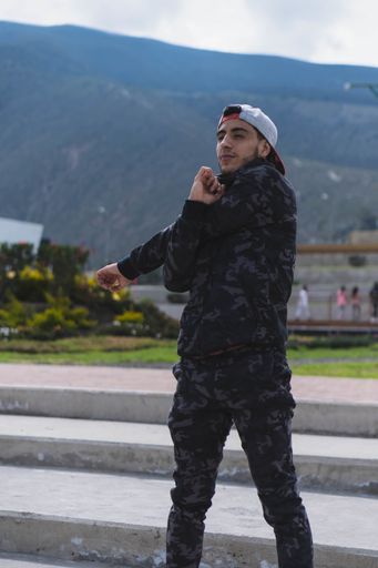 A young sportsman doing different warm-up and cardio exercises in the park - sport session