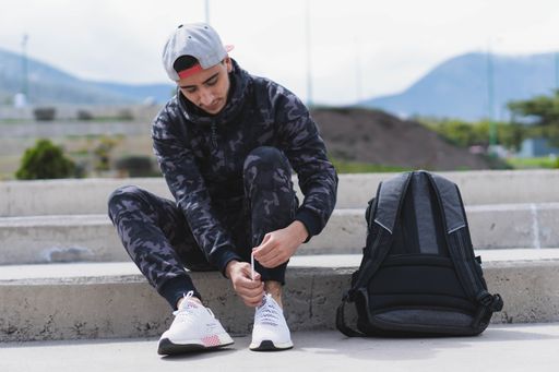A closeup shot of a young male getting ready to do a workout in the park