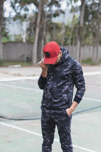 A young sportsman listening  to music or voice message from phone and getting ready to do a workout