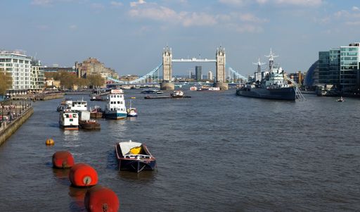 River Thames, London, United Kingdom, looking west from London Bridge, with Tower Bridge and HMS Belfast in distance and boats and buoys in foreground
