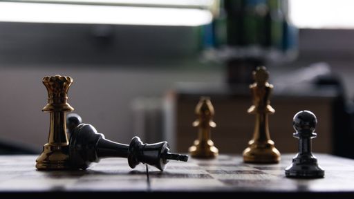 A closeup shot of the king chess peace fallen on the chess board - concept of defeat