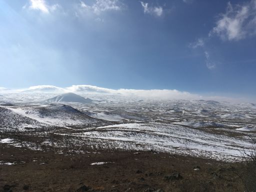 The beautiful fields covered in snow and amazing cloudy sky in the background