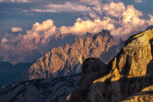 An impressive shot of rocky mountains in a daytime under the cloudy sky
