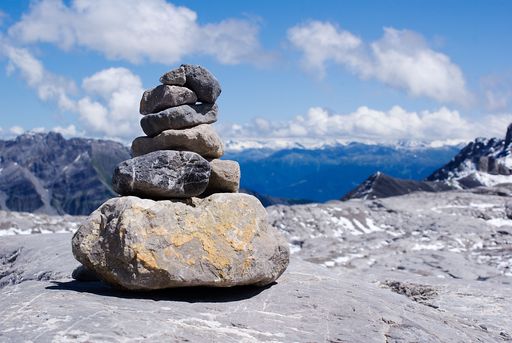 A closeup shot of rocks stacked on top of each other with a beautiful landscape in the background