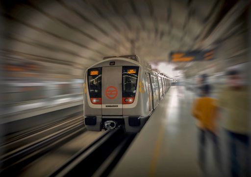 A long exposure shot of a modern train arriving at the station, Delhi Metro, India