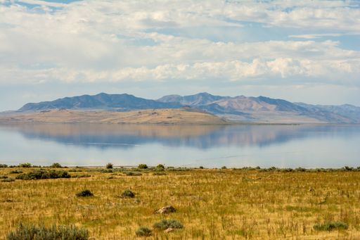 A beautiful shot of the water in the lake near a mountain ranges