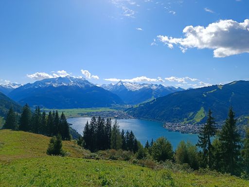 A beautiful shot of a landscape with a lake surrounded by mountains under the clouds
