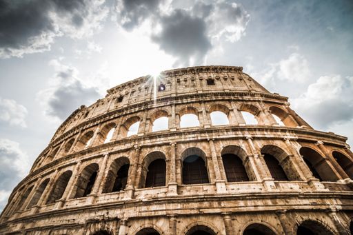 A low-angle shot of the Colosseum under the cloudy sky in Rome, Italy