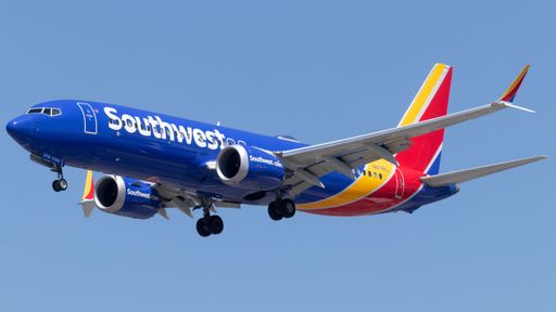 A Southwest Airlines aircraft soaring against a blue sky backdrop.