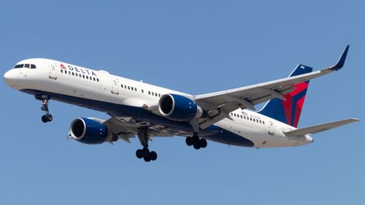 A Delta Airlines aircraft soaring against a blue sky backdrop.