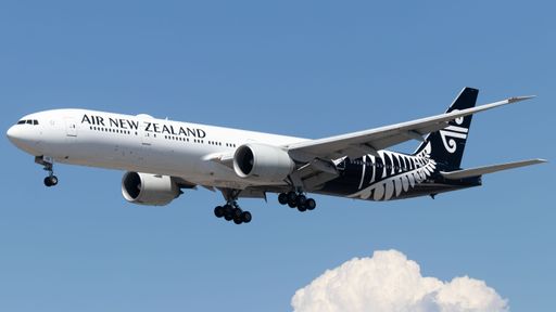 An Air New Zealand aircraft soaring against a blue sky backdrop.
