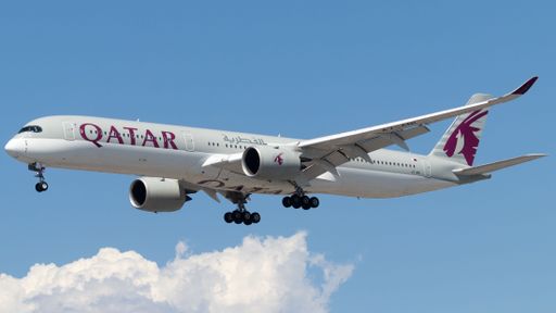 A Qatar Airlines aircraft soaring against a blue sky backdrop.