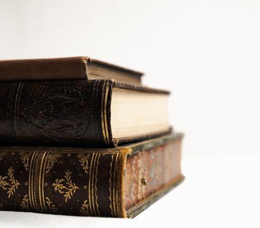 A vintage-style collection of hardcover books against a white background