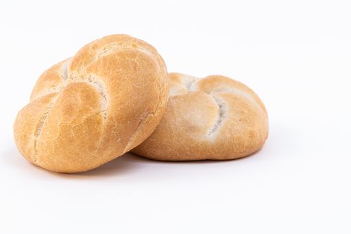 A closeup of freshly baked white bread buns isolated on a white background