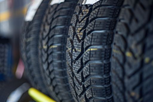 A selective focus shot of car wheels at the auto repair shop