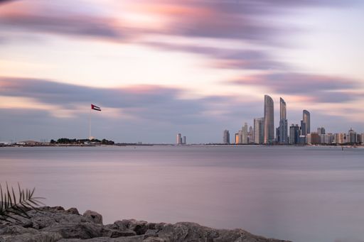 A long exposure shot of Abu Dhabi Skyline at sunset in UAE.