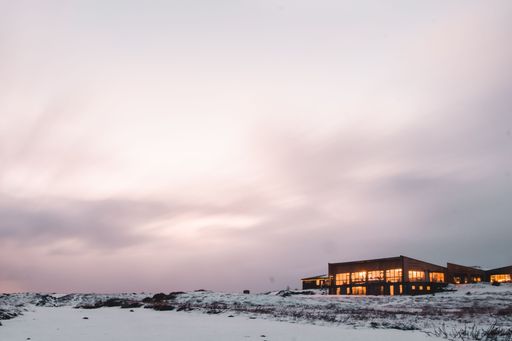 A golden sunset over the house in the middle of the snow