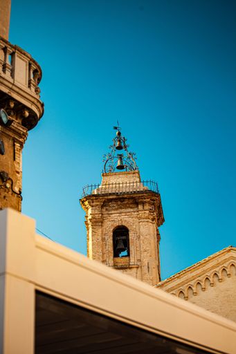 A vertical low angle shot of a stone church tower in Vasto, Italy