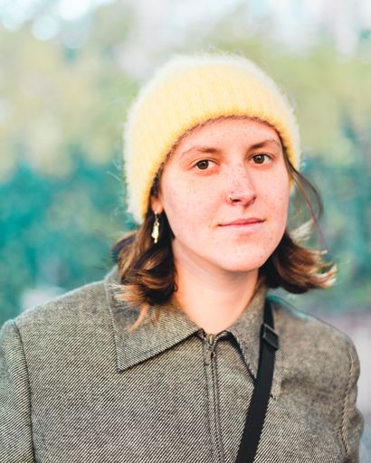 Portrait of a Caucasian attractive woman smiling and wearing a fashionable hat and sweater