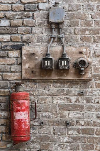 An old fire extinguisher and switches in an abandoned factory