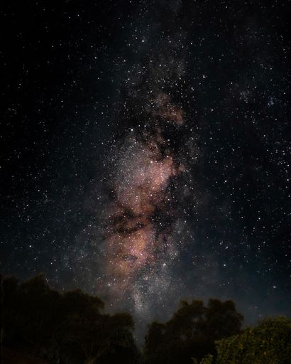 This picture features a stunning night sky illuminated by the Milky Way Galaxy