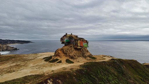 An old wooden house on the edge of a rock at Gray Whale Cove State Beach in California
