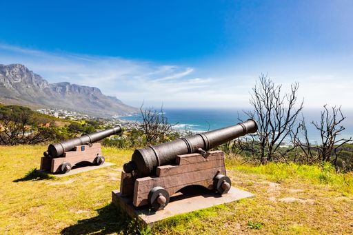 A closeup shot of vintage bomb cannons pointed at the ocean in Cape Town, South Africa