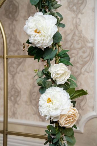 A vertical shot of beautiful flower garland with white Chinese peonies