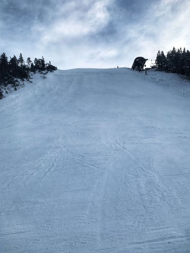A vertical shot of a snowy slope of a hill in Killington Ski Resort, Vermont, New England, Canada