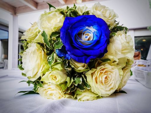 A closeup shot of a bridal bouquet with a blue rose - Concept of Uniqueness