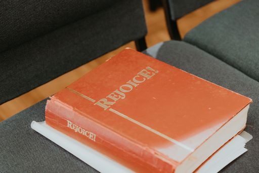 A book with name' rejoice' on chair