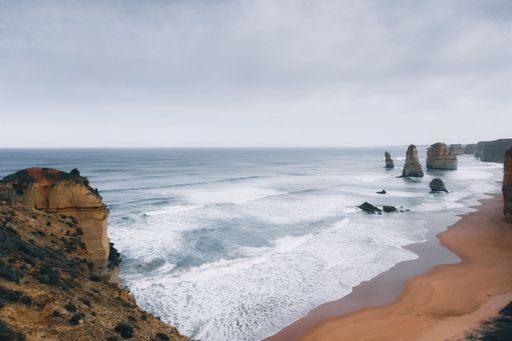 The Twelve Apostles under a cloudy sky in Great Ocean Road, Australia