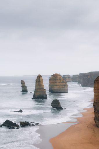 The Twelve Apostles under a cloudy sky in Great Ocean Road, Australia