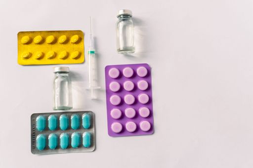 Various medical equipment, thermometer, ampoules, pipette, drugs, tablets, capsules, spray, patch, syringe, vials on a white background. Medicine,