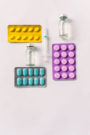 Various medical equipment, thermometer, ampoules, pipette, drugs, tablets, capsules, spray, patch, syringe, vials on a white background. Medicine,