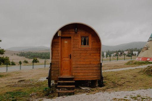 An old wooden building trailer as a tiny house in the garden